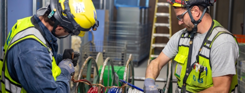 Two electricians working in a commercial building