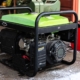 Generator in the snow near a garage.