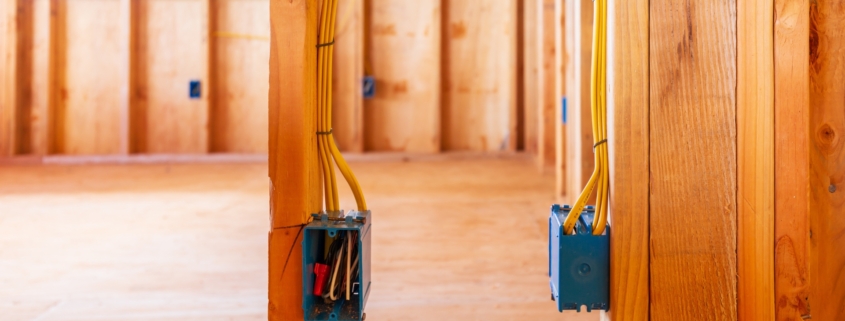 Interior of a home under construction with electrical boxes and wiring.