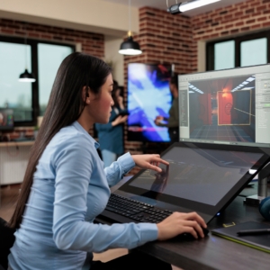 Woman in blue shirt using a computer in an office.