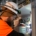 Electrical contractor in safety gear performs maintenance on a commercial electrical system.