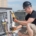 HVAC technician on the roof of a home performing a maintenance check.