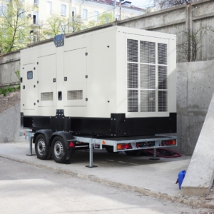 Large white generator next to a building.