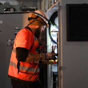 Commercial electrician repairing wiring.