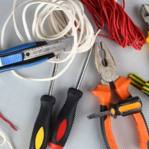 Electrical tools including wires, wire cutters, and screwdrivers.