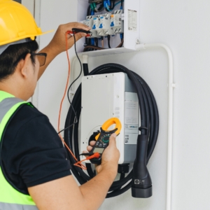 Residential electrician fixes home electrical panel.
