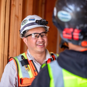 Residential electrician in hard hat and safety goggles and vest.