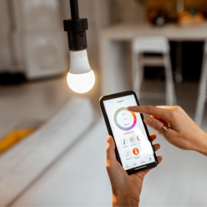 Person adjusting thermostat temperature on smartphone.