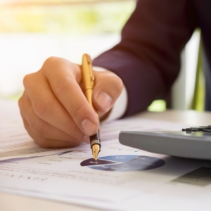 Man reviewing report showing pie graph.