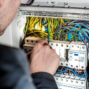 Electrician rewires a home electrical panel.