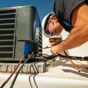 Electrician rewiring a commercial HVAC system.