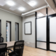 Office with conference table and black chairs.