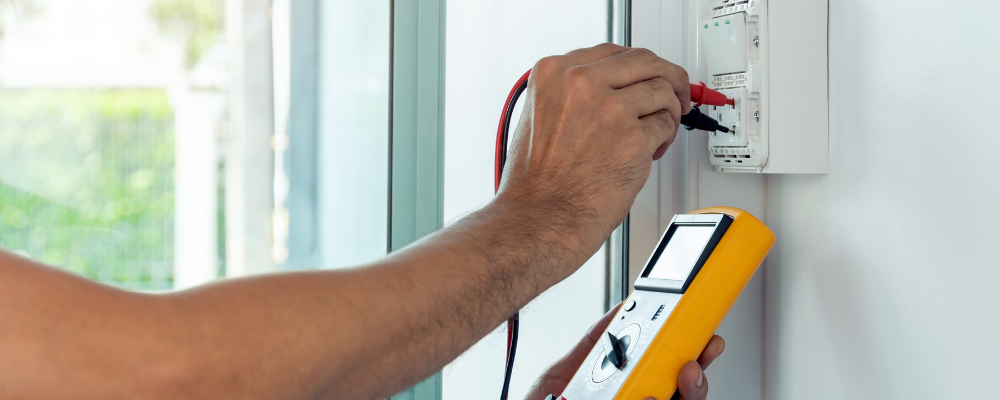 Electrician testing an outlet.
