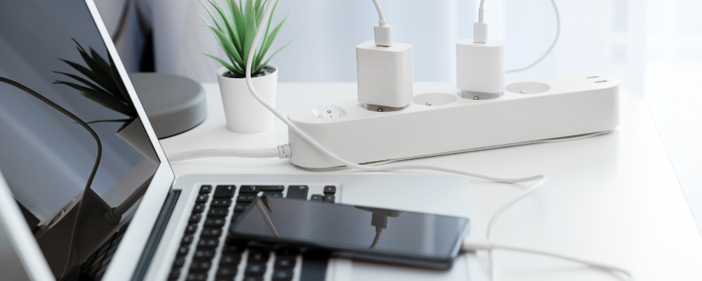 Power strip, Mac laptop, and iPhone.