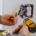 An electrician using a power tool on a light switch.