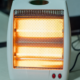 An image of a space heater with glowing heating elements.