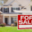 A for sale sign in front of a house.